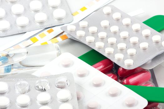 Pills of many shapes and colors grouped together.
