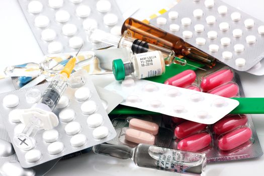 Pills of many shapes and colors grouped together.