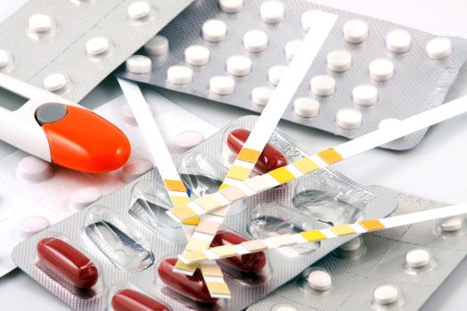 Pills of many shapes and colors grouped together.