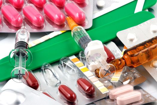 Pills of many shapes and colors grouped together.