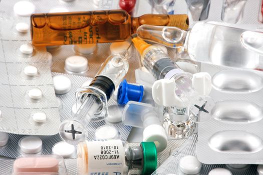 Pills of many shapes and colors grouped together.