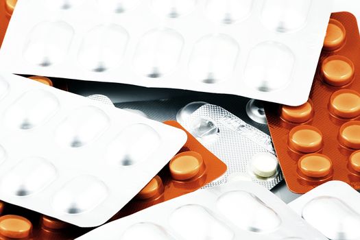 Pills of many shapes and colors grouped together.