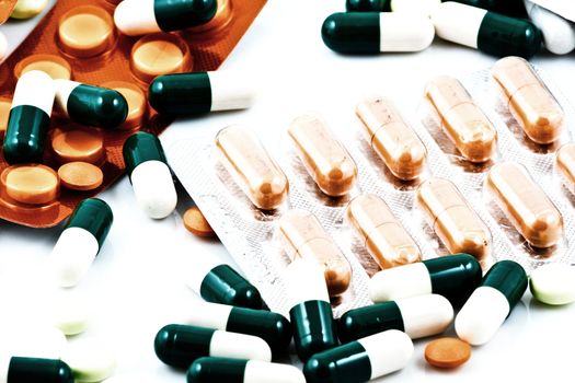 Pills of many shapes and colors grouped together.