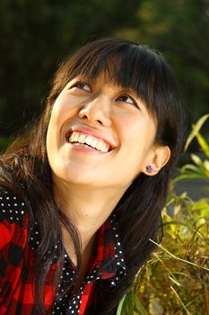 Asian woman smiling under sunshine