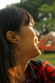 Asian woman smiling under sunshine