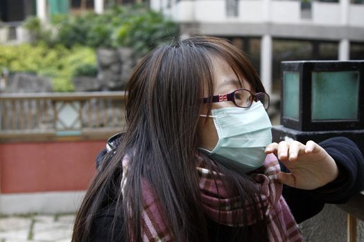 Asian sick girl wearing mask