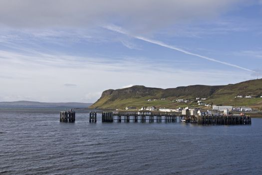 scottish coast with peer and hills in background