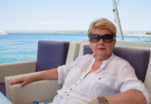 The woman at the table of street cafes.  Croatia