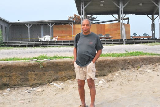 African American male standing on the beach.