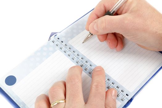 Close-up of hand beginning to write on notes on white background