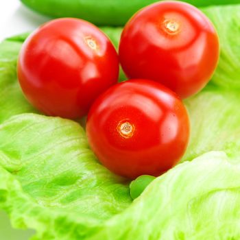 tomato,peas and lettuce on a plate isolated on white