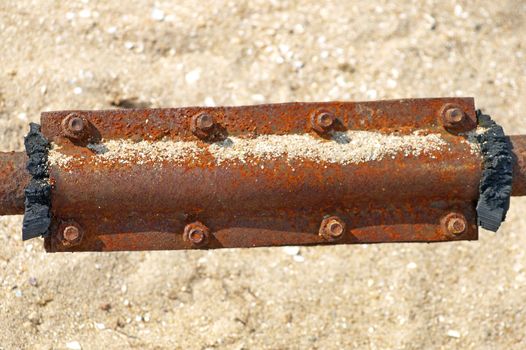 Rusty metal patch on a water pipe.