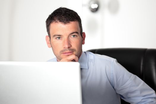 young pensive businessman in office