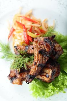 chicken legs and salad on white dish