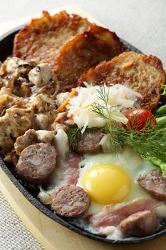 meat with egg and slapjacks in pan