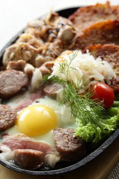 meat with egg and slapjacks in pan
