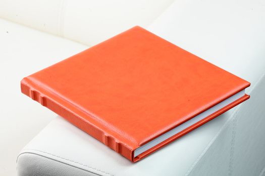 orange leather book on bright background