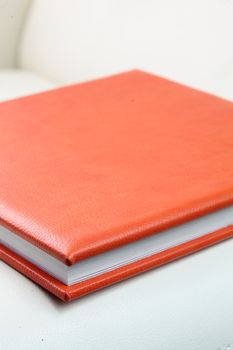 orange leather book on bright background