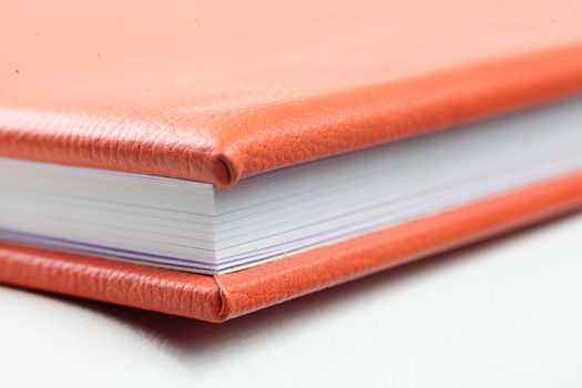 orange leather book on bright background