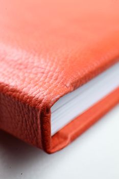 orange leather book on bright background