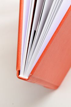 orange leather book on bright background