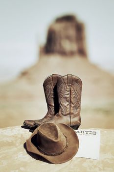 wanted poster, boots and hat in Monument Valley
