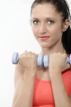 Athletic young woman working out with free weights