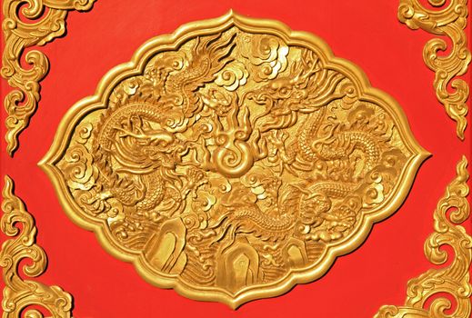 detail of golden ornamental art on chinese wooden door