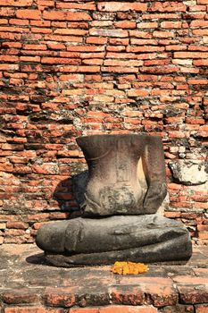 headless buddha statue in temple ruin wall near bangkok thailand
