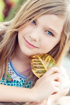 Portrait of a blode girl outdoors in the park 