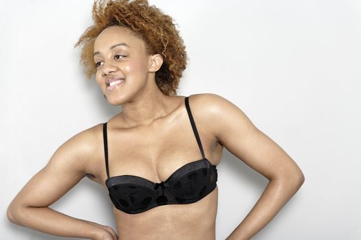 Sexy young black woman in lingerie smiling in lingerie smiling