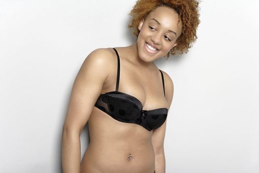 Sexy young black woman in lingerie smiling in lingerie smiling