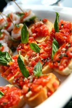 Canape juicy tomatoes on fresh bread pesto as topping