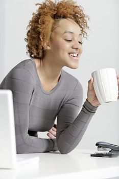 Beautiful young business woman taking a break at her desk