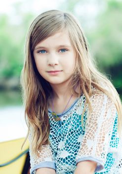 Portrait of a blode girl outdoors in the park 