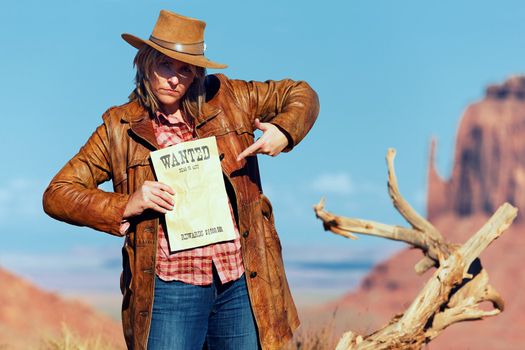 bad cowgirl with wanted paper at Monument Valley