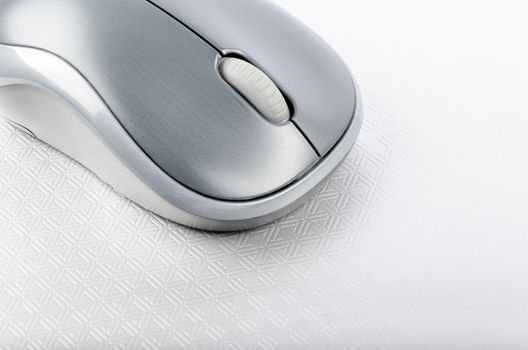 Wireless computer mouse on a metallic background