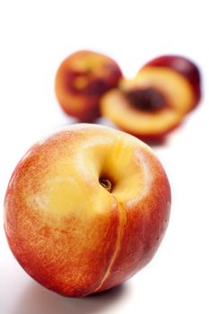 Whole and sliced fresh ripe Nectarines on an isolated background