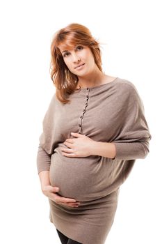 Young beautiful pregnant female standing on white background holding her tummy