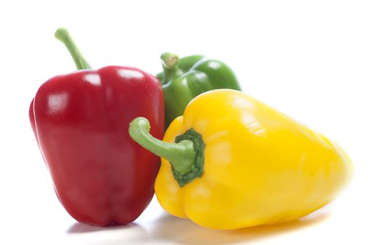 Red Yellow and Green peppers laid out next to each other