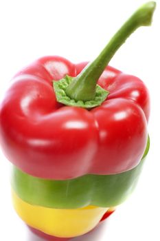 Red Yellow and Green peppers sliced and mixed up to look like one pepper on isolated white background