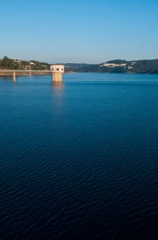 stunning view of river Zezere and Castelo de Bode Dam in Tomar, Portugal (gorgeous blue sky)