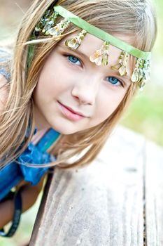 Portrait of a blode girl outdoors in the park 