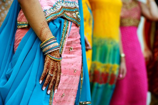 Image detail shot of henna tattoo and saris