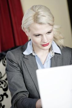 Attractive woman working on her laptop catching up after a long day.