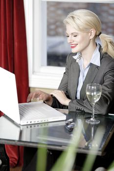 Attractive woman working on her laptop catching up after a long day.