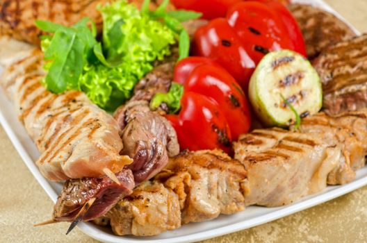 BBQ meat with vegetables and greens closeup