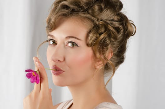 beauty woman closeup portrait with flower over grey background