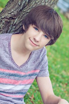 Portrait of young boy in the park looking at the camera