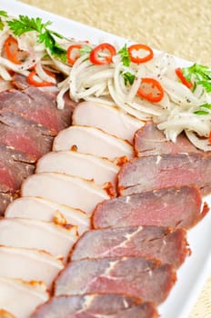 Cutting sausage and meat on a celebratory table